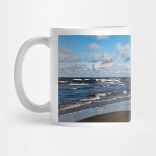 White cumulus clouds in sky over wavy Baltic sea Mug